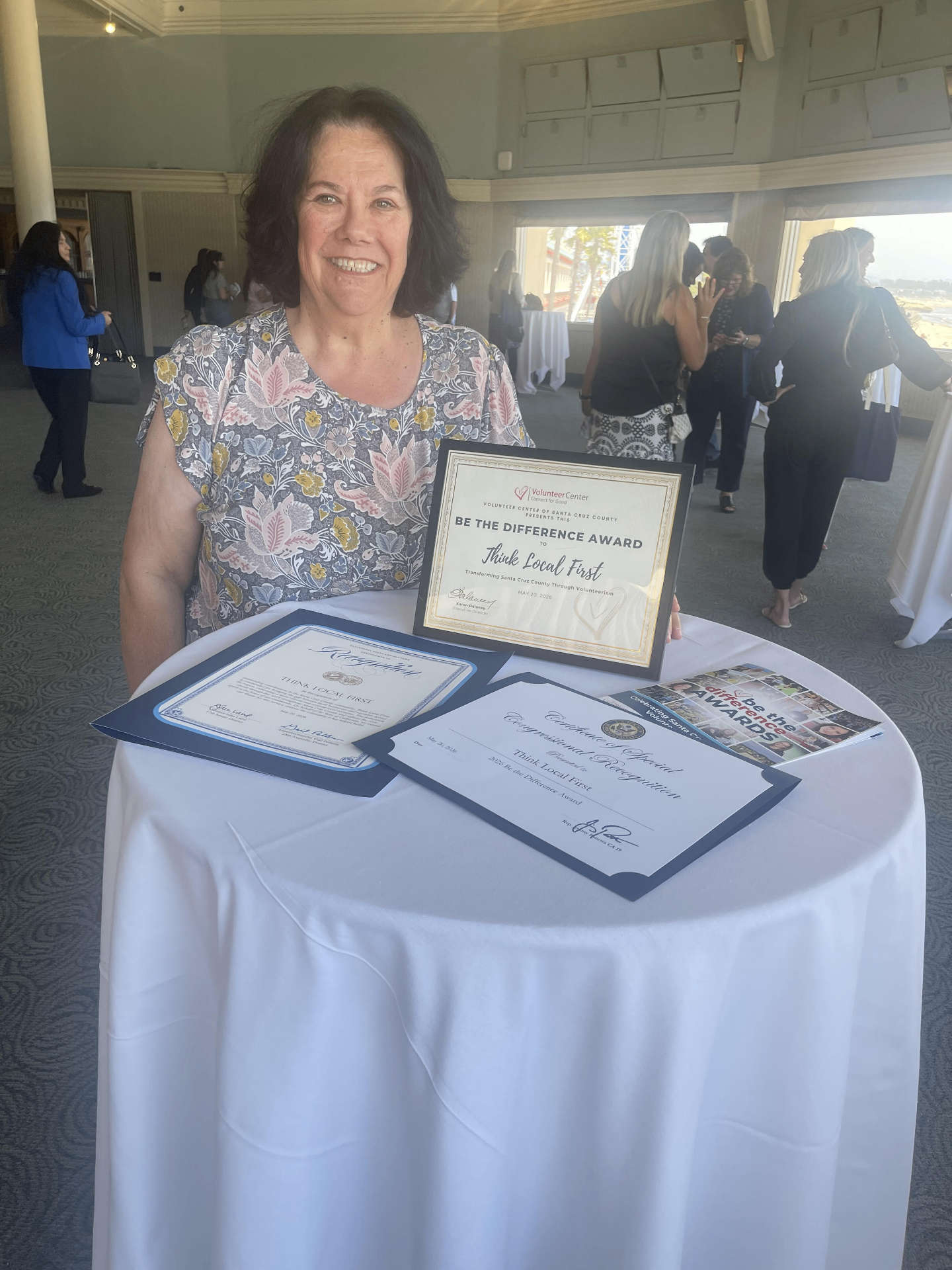 Cami with the Be the Difference Award and Certificates of Recognition for Think Local First