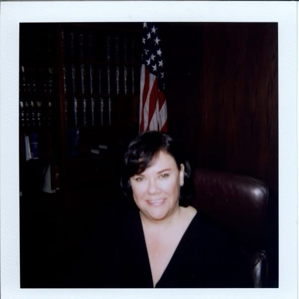 Cami Corvin in chambers in front of the U.S. flag during her service with the U.S. Federal Court